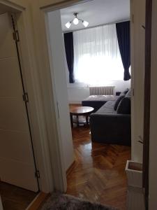 a living room with a couch and a window at Emili apartment in Belgrade +10 photos