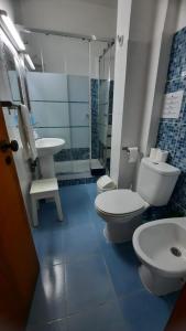 a bathroom with two toilets and a sink at Nora Velha T0+1 em Tavira in Tavira