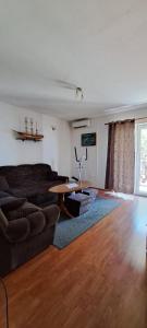a living room with a couch and a table at Dama Apartment in Senj