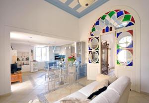 a living room with a couch and a table with chairs at Casa Di Rodi in Rhodes Town +14 photos