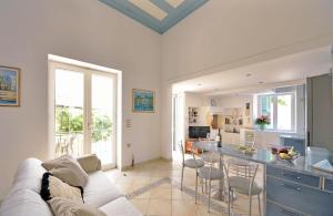 a living room with a couch and a kitchen with a counter at Casa Di Rodi in Rhodes Town