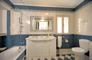 a bathroom with a sink and a tub and a toilet at Casa Di Rodi in Rhodes Town