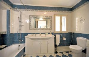 a bathroom with a sink and a tub and a toilet at Casa Di Rodi in Rhodes Town