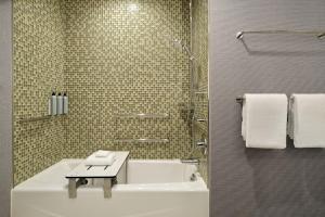 a bathroom with a tub and a sink and a shower at Residence Inn by Marriott Oakland Downtown in Oakland