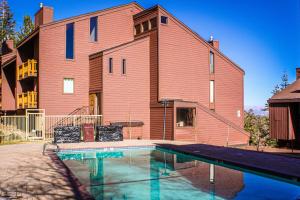 a house with a swimming pool in front of a building at Mammoth Ski & Racquet Club #131 in Mammoth Lakes