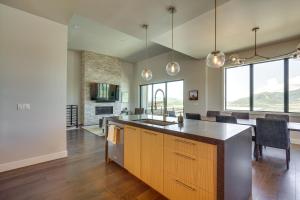 a kitchen with a island and a dining room at Hideout Haven Luxe Retreat with Lake View and Hot Tub in Keetley