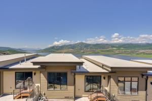 a building with a view of a river and mountains at Hideout Haven Luxe Retreat with Lake View and Hot Tub in Keetley