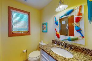 a bathroom with a sink and a toilet and a mirror at Fiddlesticks #4-2 in Avon +32 photos