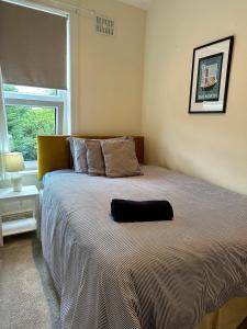 a bedroom with a large bed with a large window at Tithebarn Townhouse in Poulton le Fylde