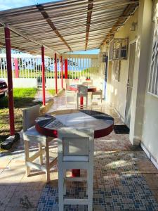 eine Terrasse mit einem Tisch und Stühlen unter Markise in der Unterkunft Villa Trinidad in La Ceiba