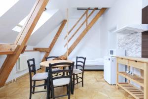 a kitchen and dining room with a table and chairs at Beethoven Apartments in Bratislava