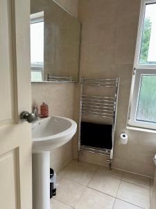 a bathroom with a sink and a mirror at Tithebarn Townhouse in Poulton le Fylde