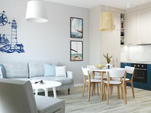 a living room with a couch and a table at Stacja Baltic Twins in Sztutowo