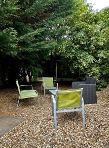 波頓勒費德的住宿－Tithebarn Townhouse，三把椅子和一张桌子在一堆树叶里