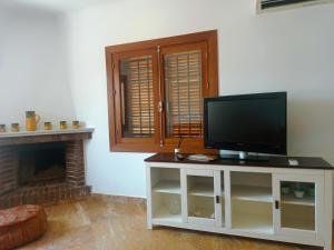 a living room with a tv and a fireplace at Rentaly Holidays Playa Villaricos in Cuevas del Almanzora
