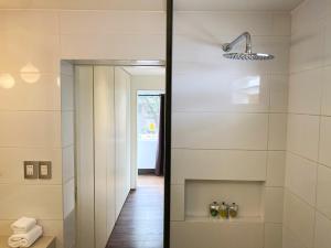 a bathroom with a walk in shower next to a mirror at Luxury 2BR in Blas Cerdeña San Isidro in Lima +15 photos