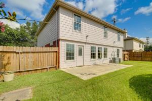 a white house with a wooden fence in a yard at Houston Vacation Rental 14 Mi to Downtown in Houston