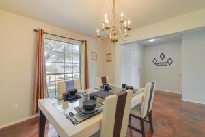 a dining room with a table and chairs and a chandelier at Houston Vacation Rental 14 Mi to Downtown in Houston