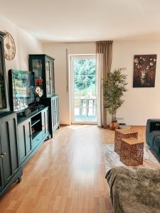 a living room with a couch and a tv at Panorama-Refugium in Bad Koetzting