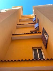 an external view of a building with stairs and windows at Belix Hotel Apartments, Near the Beach in Durrës