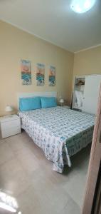 Schlafzimmer mit einem großen Bett mit blauer Decke in der Unterkunft Casa Mare Blu Agropoli - Blu Zaffiro in Agropoli