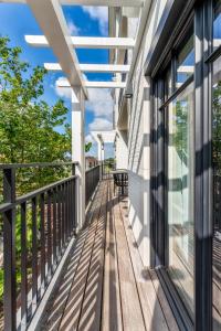 a balcony of a home with a wooden deck at Zonnig Luxueuze Appartementen La Coronne in Knokke-Heist