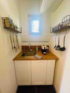 a kitchen with a sink and a counter with utensils at Albergue Haid 