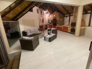 a large living room with couches and a table at T&M Guesthouse in Johannesburg