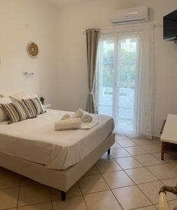 a bedroom with a bed and a sliding glass door at Fabrika Apartments in Vári