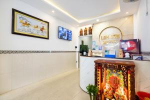 a shop with a counter and a sign on the wall at Lam Sơn Hotel in Ho Chi Minh City