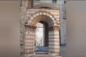 an archway in a brick building with an entrance at Lovely apartment in the heart of Perugia in Perugia