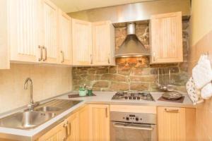 a kitchen with a sink and a stove at Lovely apartment in the heart of Perugia in Perugia