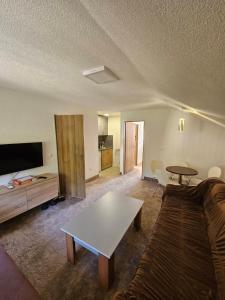 a living room with a couch and a table at Delimustafić apartmani in Visoko