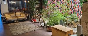 a chair and a bike in a room with plants at Hotel Urban Parque 93 in Bogotá