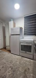 a kitchen with a stove and a refrigerator at Vista Sarajevo Old Town in Sarajevo