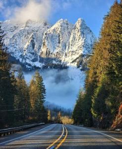 a road with a snow covered mountain in the distance at Surprisingly Styish Stays in Hoquiam