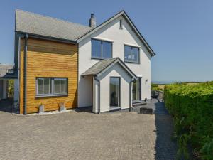 a house with a brick driveway in front of it at Skerries in Dartmouth