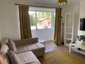 a living room with a couch and a window at House number 8 sleeps up to 6 People with Smart TVs in Every Room in Wellington