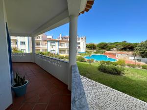 a balcony with a view of a swimming pool at Best Houses 91 - Casa D'el Rey in Amoreira