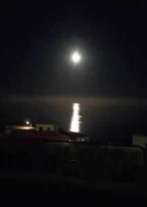 a full moon over the ocean at night at La Lunita in Valverde