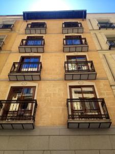 a building with balconies on the side of it at Apartamentos Caballero de Gracia in Madrid