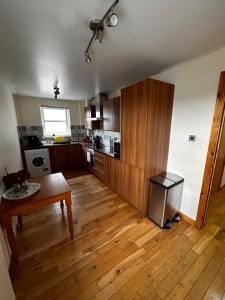 a kitchen with wooden floors and a table in a room at Metro 8 Inverness City Centre in Inverness