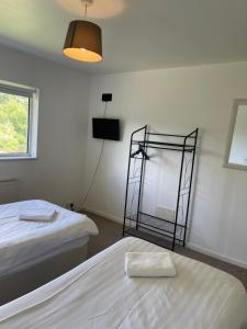 a room with two beds and a mirror on the wall at House number 8 sleeps up to 6 People with Smart TVs in Every Room in Wellington