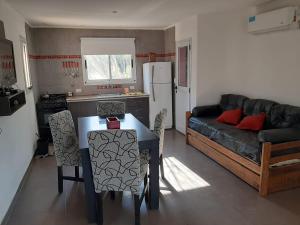a kitchen and living room with a table and a couch at Indigo CCH in Carpintería