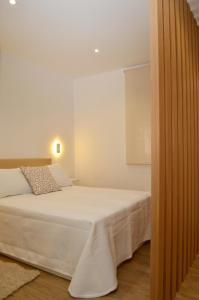 Ένα ή περισσότερα κρεβάτια σε δωμάτιο στο Apartamentos A CASA DO REMO
