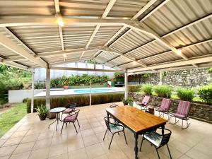 a patio with a table and chairs and a pool at Casa Johanna, Charm and Tranquillity ! in Atenas