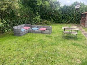 a couch with pillows sitting in a yard at House number 8 sleeps up to 6 People with Smart TVs in Every Room in Wellington