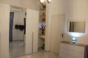 a bathroom with a mirror and a television in a room at Casa Nonna Nina in Trabia