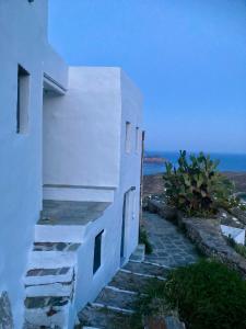 a white building with stairs next to the ocean at Castle seaview retreat in Alona