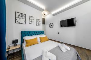 a bedroom with a bed and a tv on the wall at Seaside Apartment 1 in Hersonissos